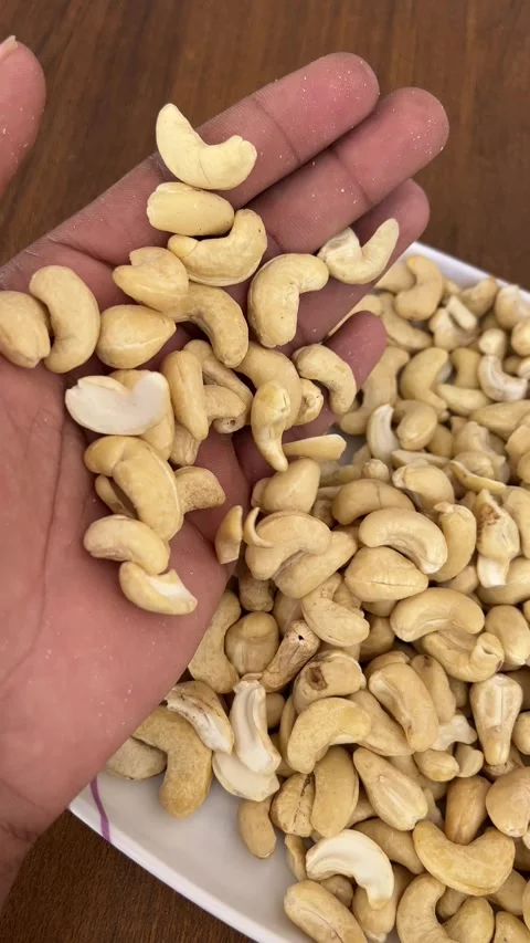 Cashew Nuts Falling from Hand into Plate – Close-Up 4K Footage Stock Footage 323271330