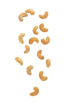 Cashew nuts falling isolated on white background with clipping path Stock Photos
