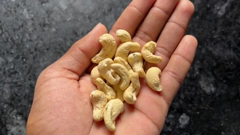 Cashew Nuts in Hand Close-Up | Fresh Kaju Display and Healthy Dry Fruit Concept Видео 319767987