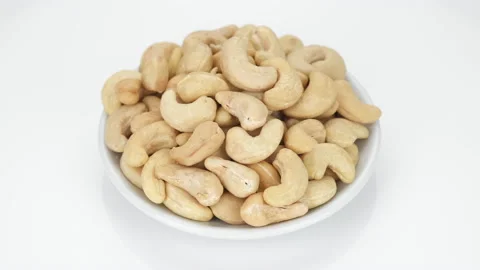 Cashew nuts isolated on white background, rotation. Healthy Food Stock Footage 153069885