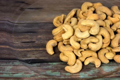 Cashew nuts on rustic plate Stock Photos