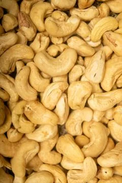 Cashew nuts scattered surface texture. Close up. Stock Photos