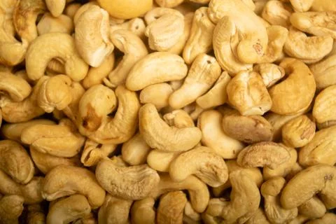 Cashew nuts scattered surface texture. Close up. Stock Photos