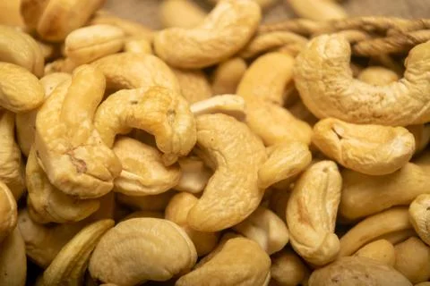 Cashew nuts scattered surface texture. Close up. Stock Photos