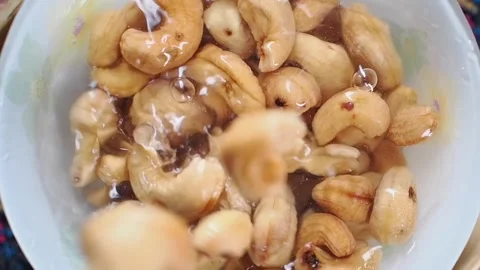 Cashew nuts soaking in water for preparation Stock Footage 341786838