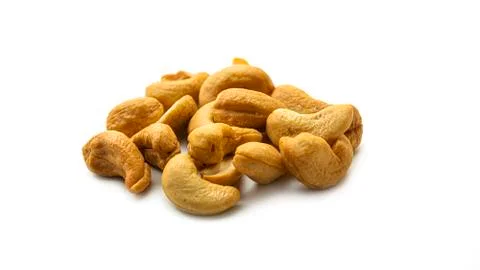 Cashew nuts on a white background. Macro photo. Stock Photos