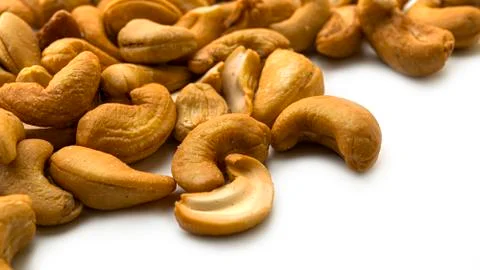 Cashew nuts on a white background. Macro photo. Stock Photos