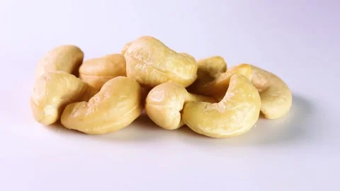 Cashew nuts on white background, rotating Stock Footage 313413426