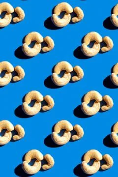 Cashew pattern on blue background, colorful flat lay food texture top view Stock Photos
