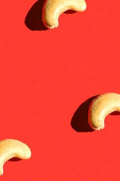 Cashew pattern on red background, colorful flat lay food texture top view Stock Photos