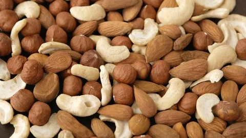 Cashews, almonds and hazelnuts rotating Stock Footage 115367410