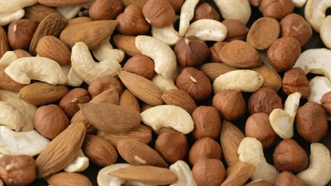 Cashews, almonds and hazelnuts rotating Video stock 115367677