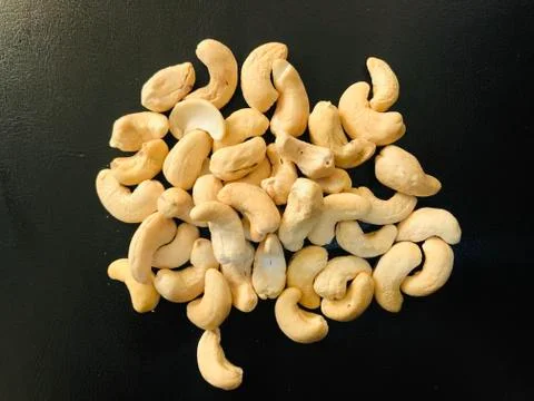Cashews on black background Stock Photos