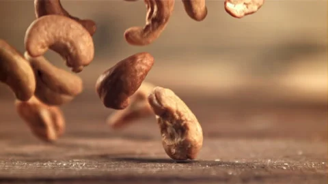 Cashews fall on the table. Filmed is slow motion 1000 fps. Stock Footage 167094052