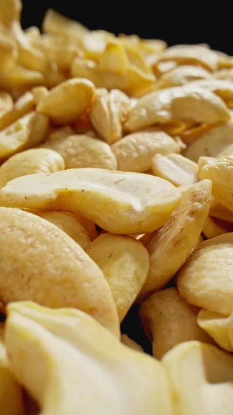 Cashews heap with falling kernels. Organic snack. Pile of cashews without shell Stock Footage 289450743