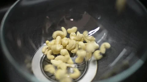Cashews Nuts drop down on a Plate Stock Footage 138985849