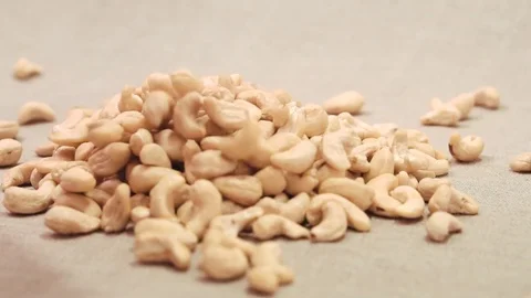 Cashews nuts falling down on a linen fabric Stock Footage 72112897