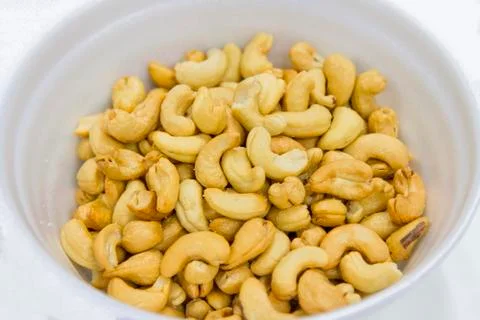 Cashews In a white container Stock Photos