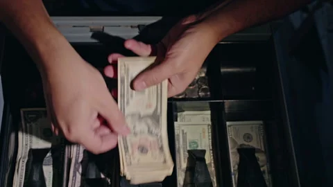 Cashier counting US dollar banknotes inside open cash register drawer, close up Stock Footage 324786476