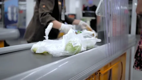 The cashier in the store scans the barcode of the goods. Stock Footage 134198778