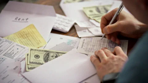 A cashier types data onto a sales receipt stamps it and records the payment Stock Footage 338187721