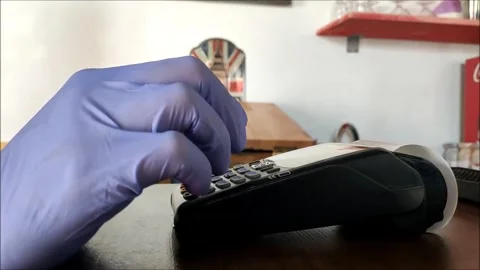 Cashless payment through the terminal gloved hand pin code check Stock Footage