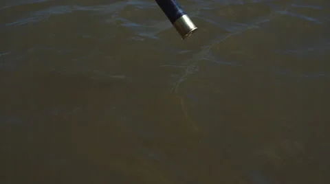 Casings falling in water Stockbeeldmateriaal 47454582