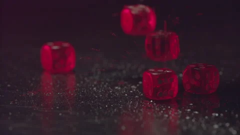 Casino-01-07-Close-up-view-of-red-casino-dice-rolling-on-wet-table-success Stock Footage 132966432