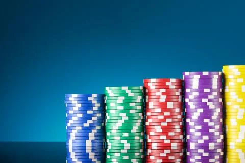 Casino chips on a black surface Stock Photos