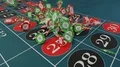 Casino chips fall on roulette table gambling drop win money 4k or 4k+ Resolution