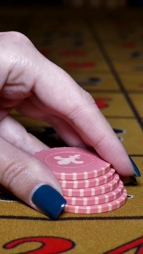 Casino. close-up of a woman's hand making a roulette bet on 31 black Stock Footage 300476857