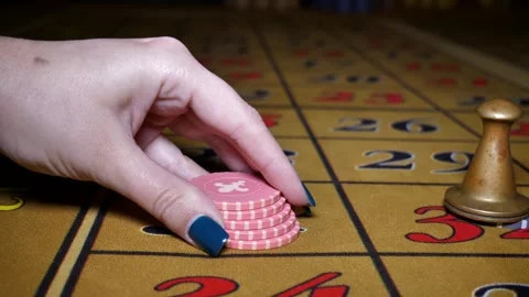 Casino. close-up of a woman's hand making a roulette bet on 31 black Stock Footage 300670949