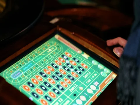 Casino: man playing electronic roulette Stock Footage 73571192