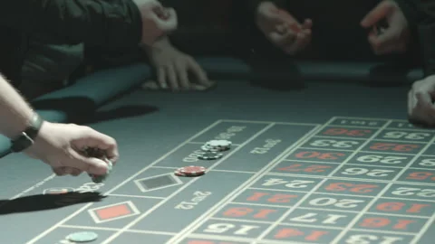 Casino roulette table placing and taking chips Stock Footage 237459123