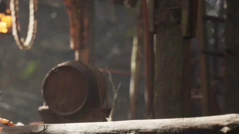 Cask sits quietly in a rustic setting with wooden logs and warm light Stock Footage 340015626