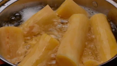 Cassava boiling in a pot with sugar to making Thai dessert or Singkong Rebus. Stock Footage 158664349