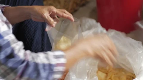 Cassava chips repackaged in plastic containers. Stock Footage 272566505