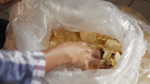 Cassava chips stored in plastic containers, taken for repackaging. Top view. Stock Footage 272566482