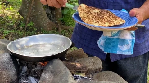 Cassava, or manioc being made over an open fire Stock Footage 234737596