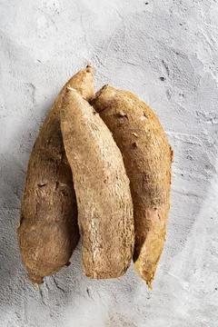 Cassava root pile, on a background of gray and white texture (Manihot escul.. Stock Photos