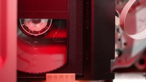 A cassette is inserted into the VCR, and the drum with the film spins Stock-Footage 237108786