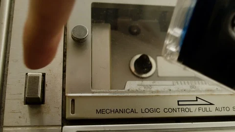 Cassette player inserts a cassette into the boombox and presses the play button. Stock Footage 125619295