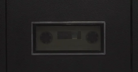 Cassette tape rolling inside a tape deck player Stock Footage