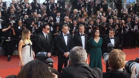 The cast and the producers of Once Upon a Time in Hollywood are posing for Stock Footage 108616893