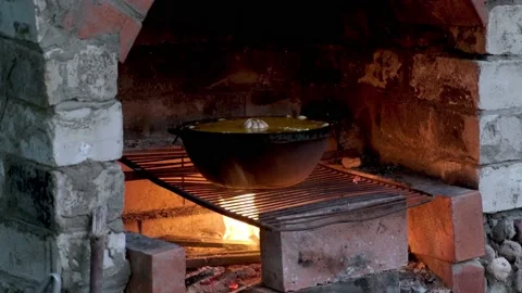 In a cast-iron cauldron, an appetizing pilaf is cooked. Stock Footage 208850325