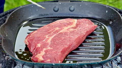 Cast iron grill heating for steak sear, outdoor cast iron skillet Video stock 324578651