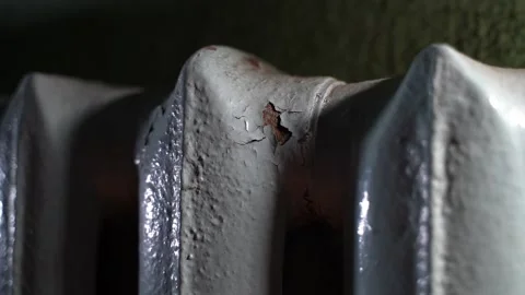 Cast iron heating radiator with peeling red and corrosion, closeup Stock Footage 240601211