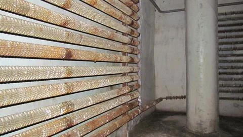 Cast iron radiators. Rusty warehouse batteries. Stock Stock Photos