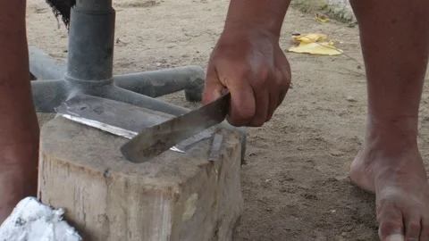 Cast lead in sheet cut with a knife and hammer on a log of wood. Detail Stock Footage 162312051