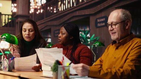 Cast members practicing script reading for a classic drama play in a library Stock Footage 313308755